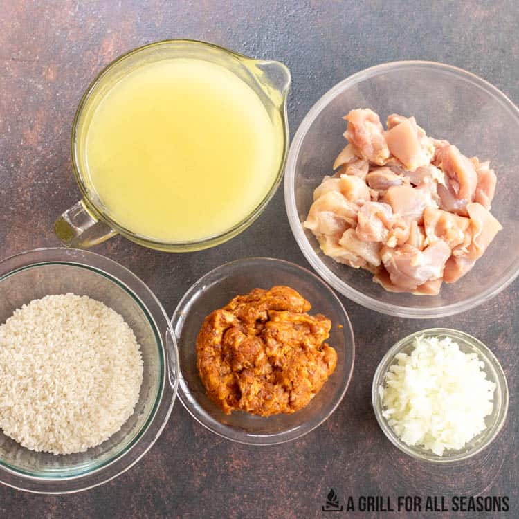 chorizo, chicken, arborio rice, and other ingredients in ramekins