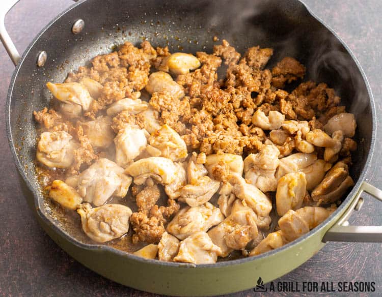 chorizo and chicken browned in a large skillet