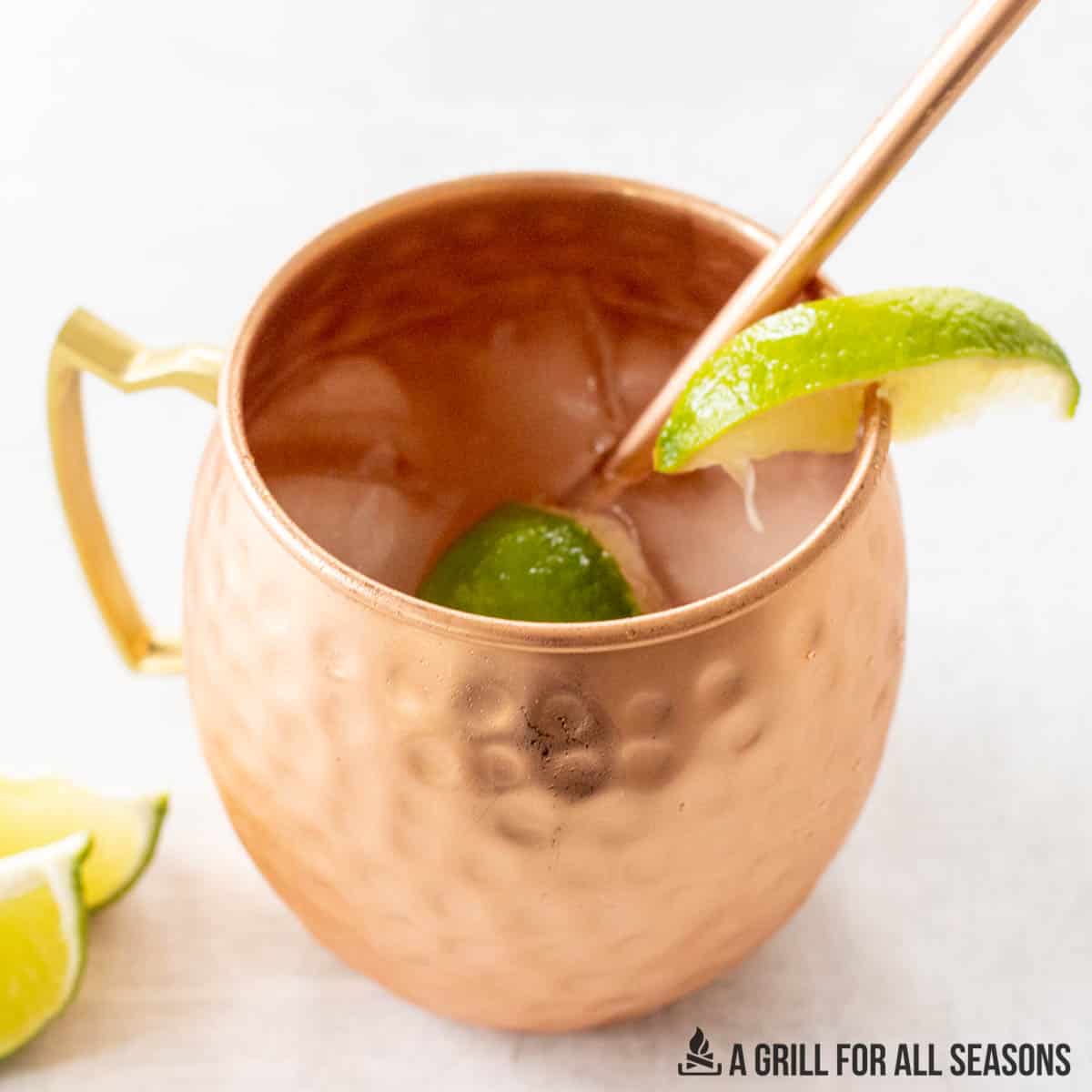 moscow mule with rum garnished with lime and straw