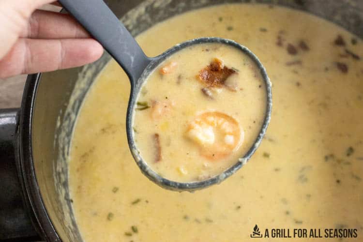 ladle lifting up some of the shrimp and corn bisque
