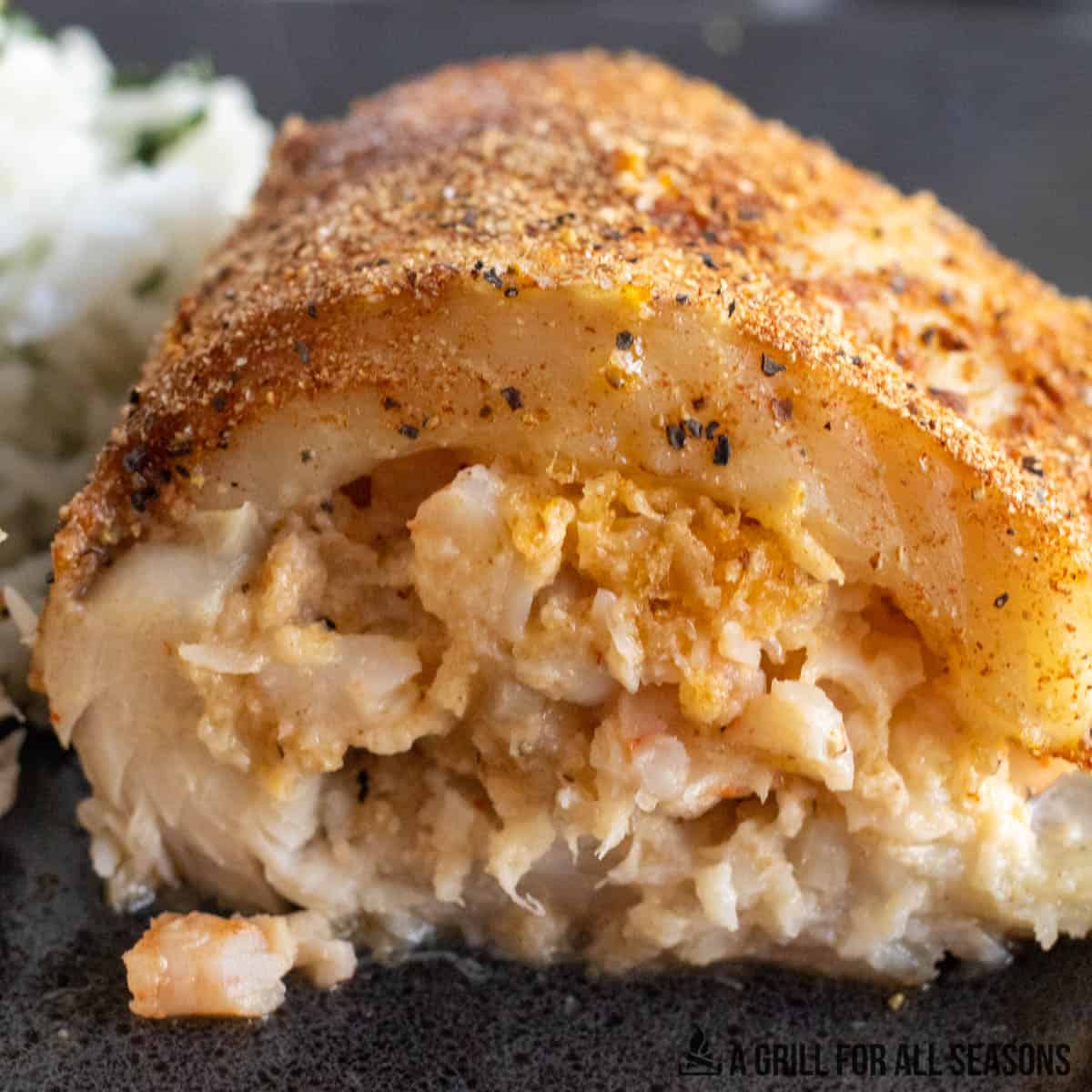 close up of smoked tilapia stuffed with shrimp cut in half to show filling