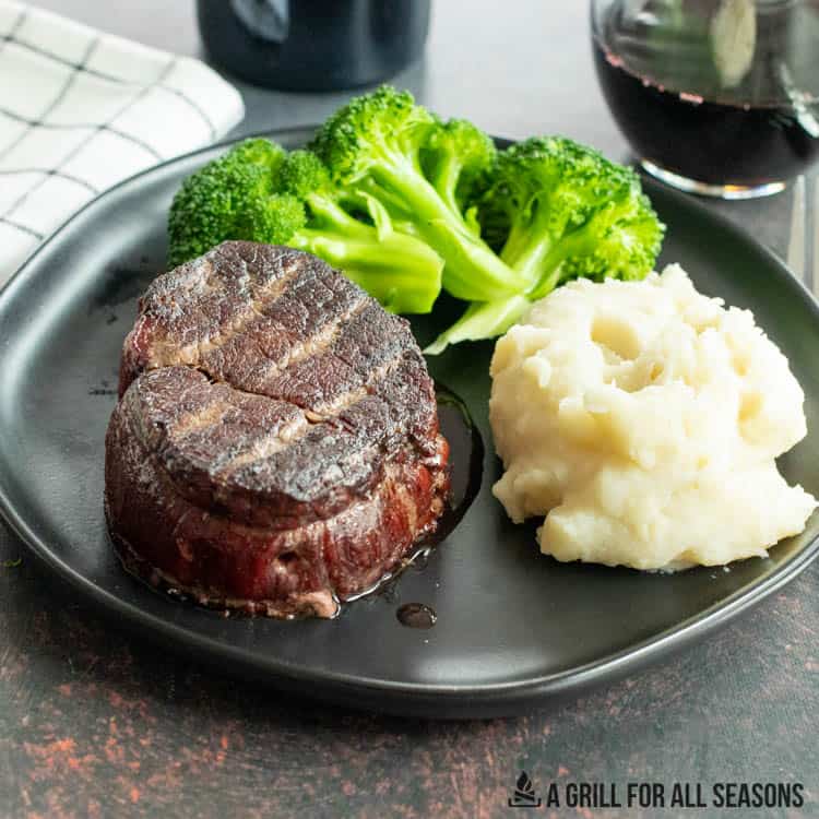 traeger filet mignon on plate with brocolli and mashed potatoes