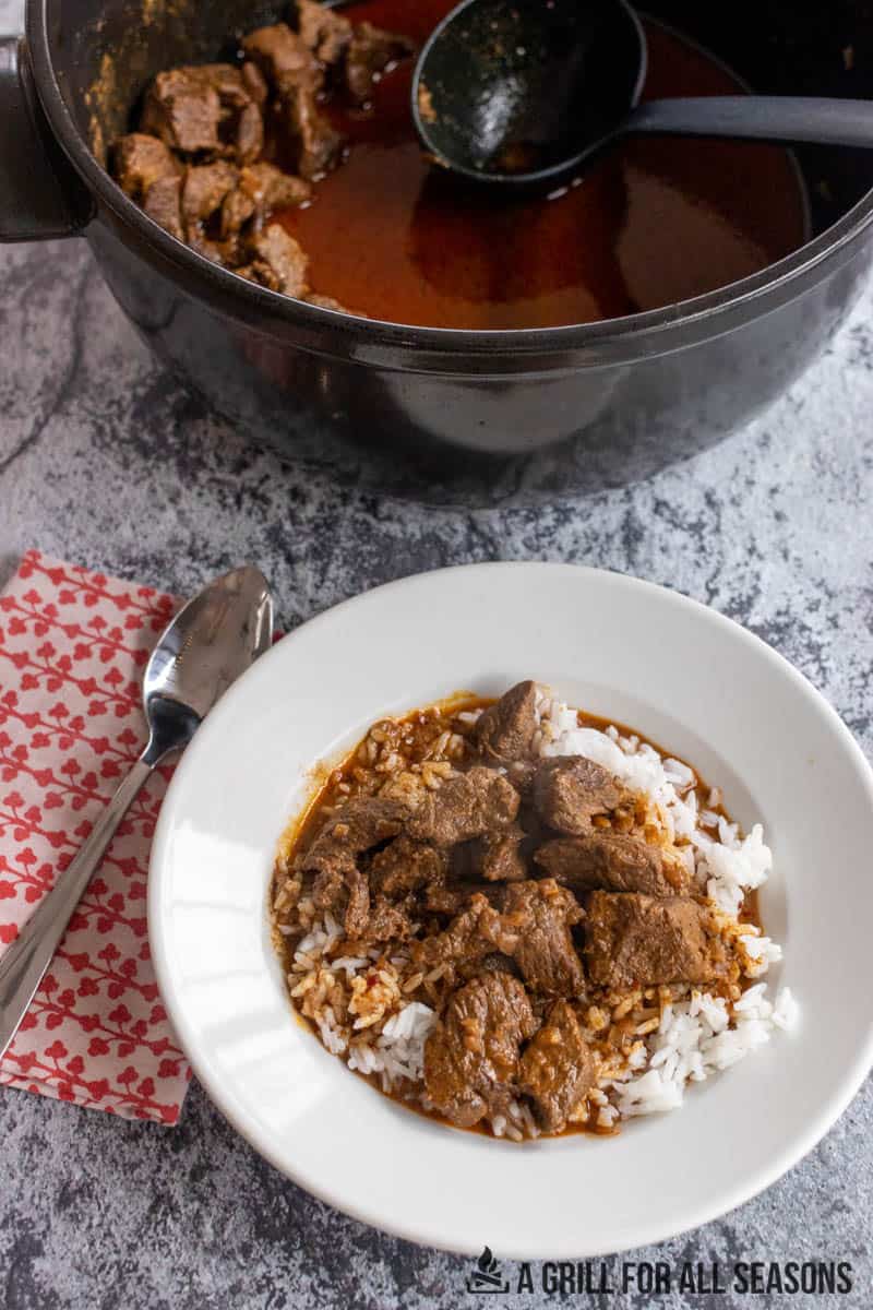 beef masala in a pot and served in a bowl