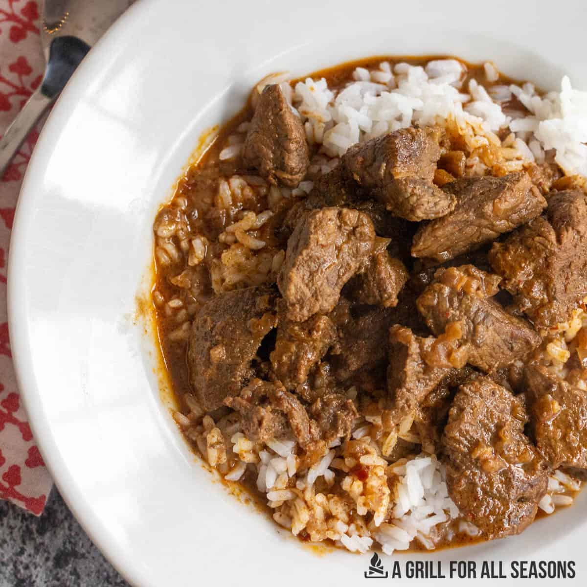 rice and beef masala in a white bowl