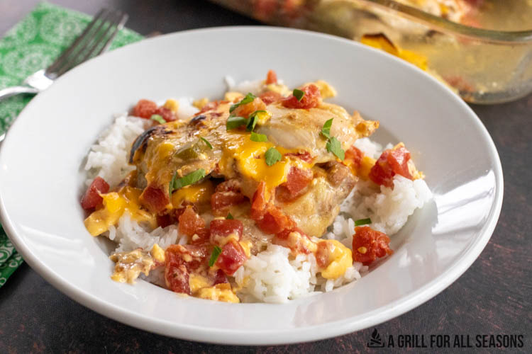 queso chicken on a plate with a bed of white rice