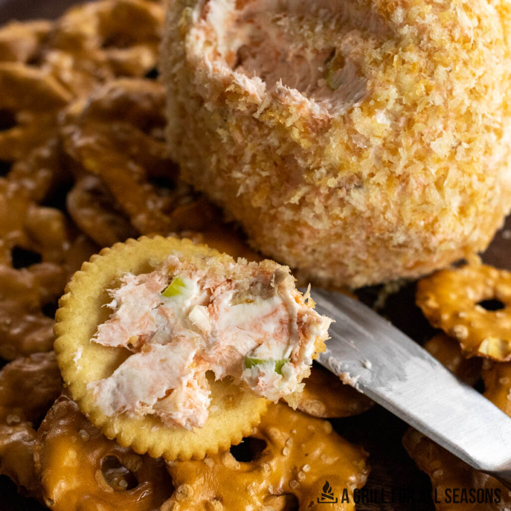 cracker covered in salmon cheese ball smear