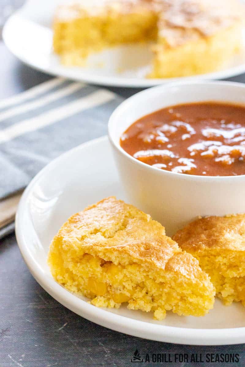 slice of air fryer cornbread next to a bowl of soup