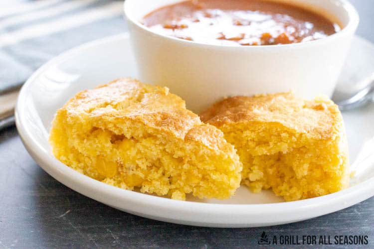 slices of air fryer cornbread next to a bowl of soup