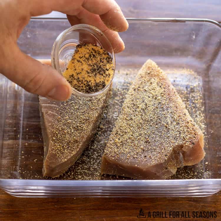 dry rub being added to fish