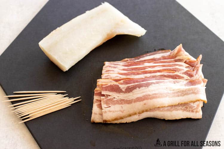 cod, bacon, and tooth pics on cutting board
