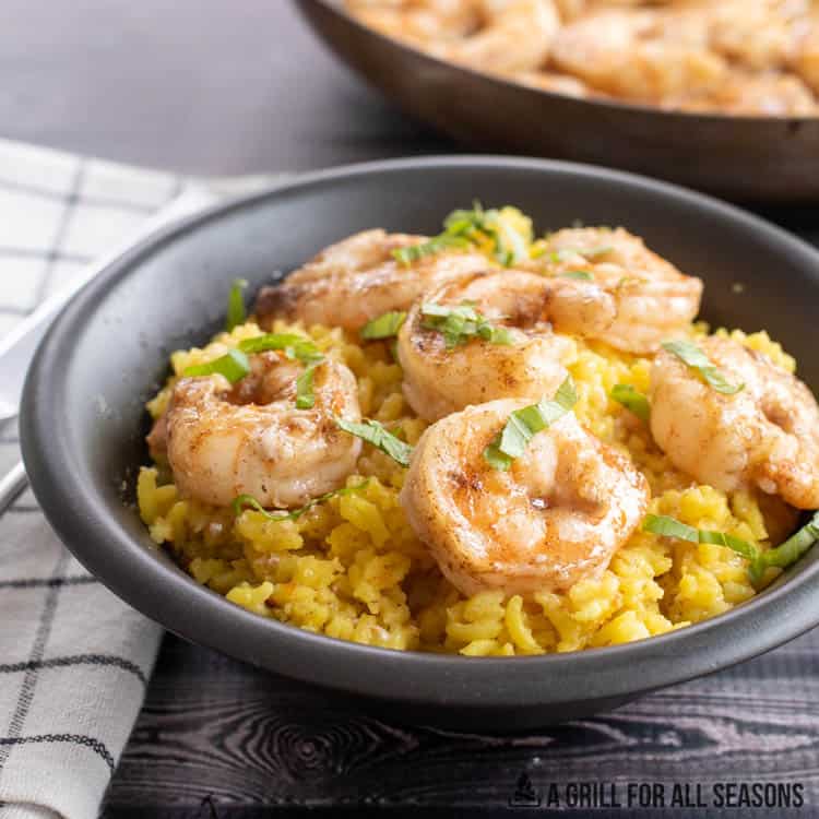 butter poached shrimp in a bowl with rice