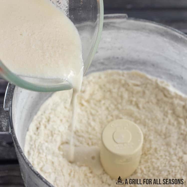 food processor with milk being added to it
