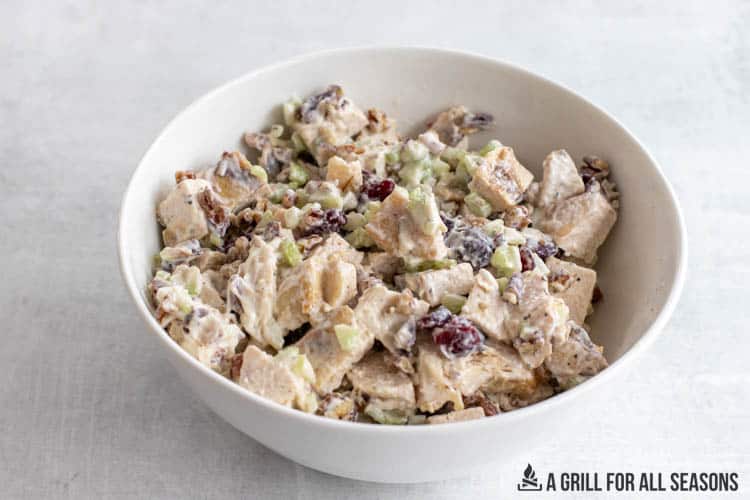 cranberry pecan chicken salad in white serving bowl