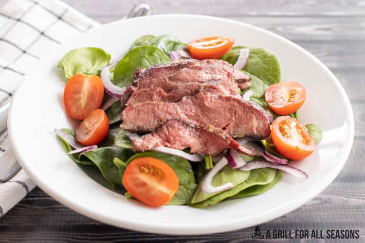 salad topped with smoked steak