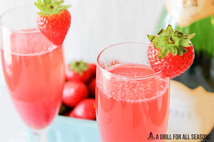 close up of tops of champagne glasses with the strawberry mimosa recipe