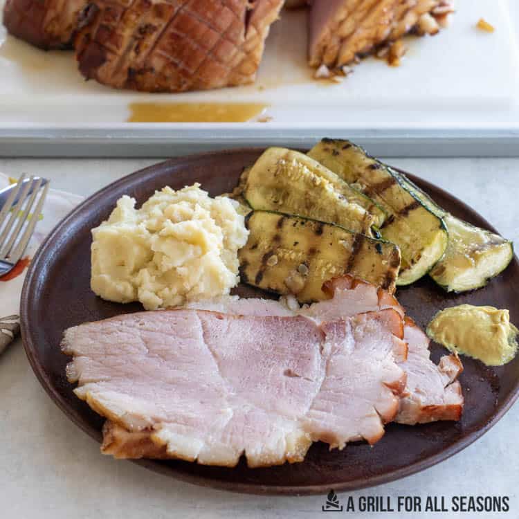ham on plate with zucchini and mashed potatoes