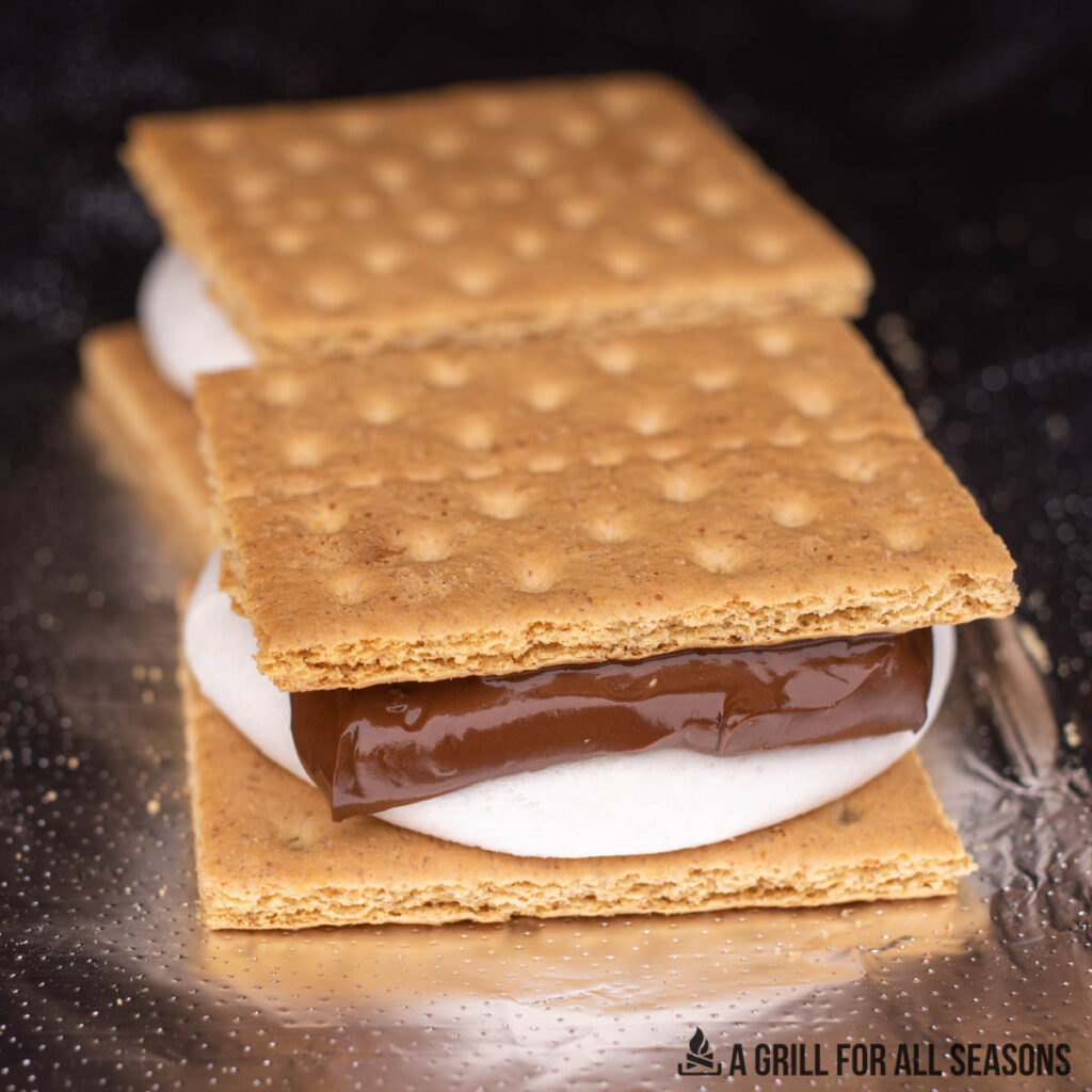 two traeger smores assembled with metled marshmallows and choclate