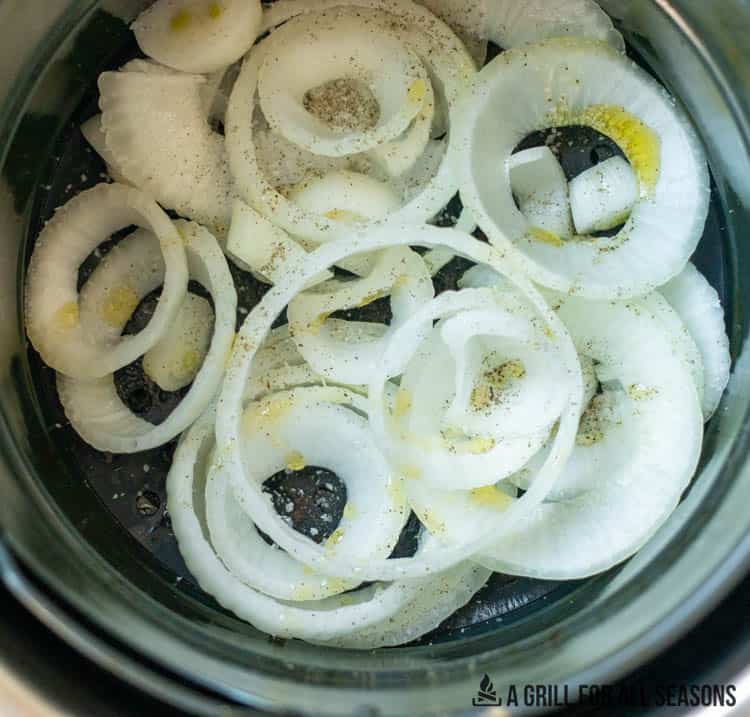 raw onions in bowl with oil