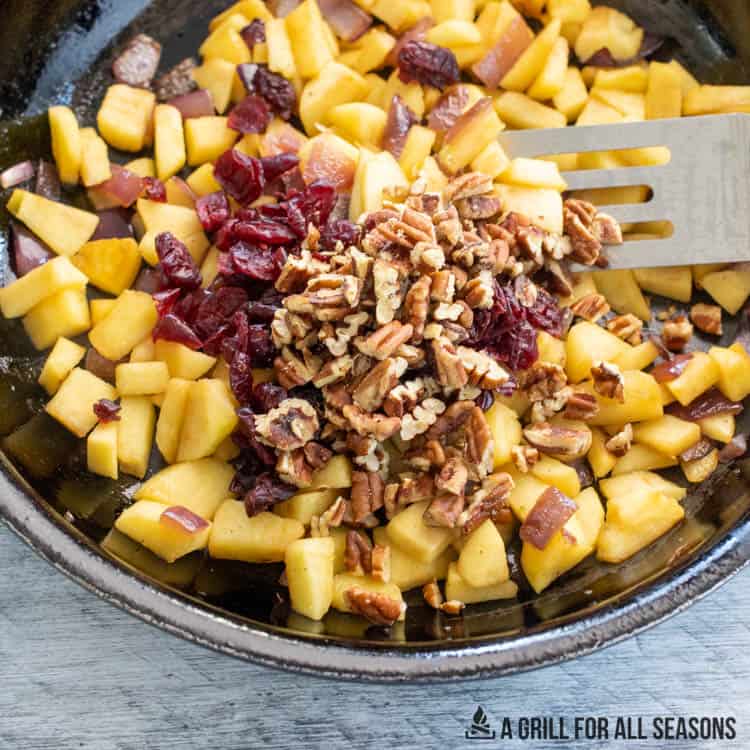 apples, pecans, and cranberries in bowl