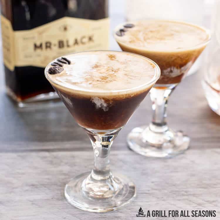 mr black creamy espresso martinis in glasses with foam and espresso beans on top