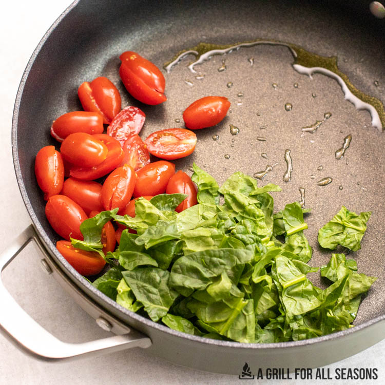 spinach and tomatoes in skillet