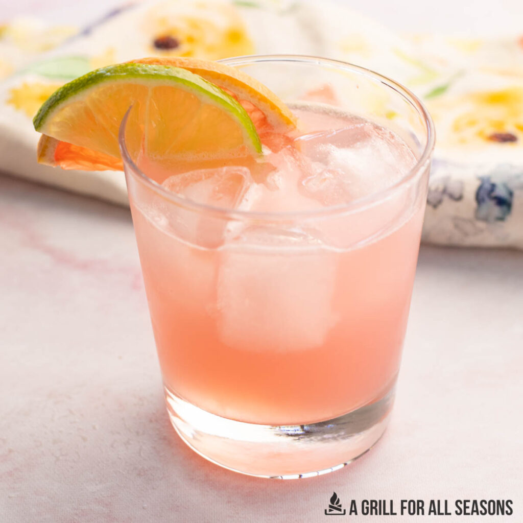 pink paloma with ice in a glass