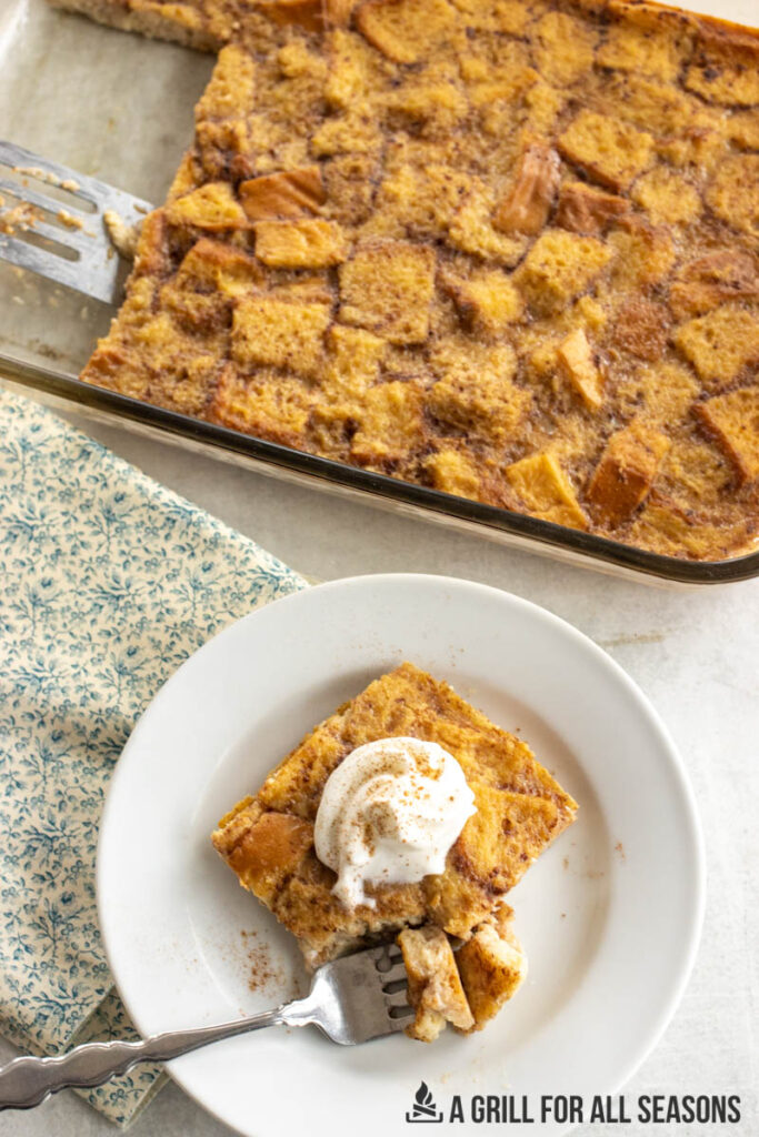 smoked bread pudding on plate with whipped cream