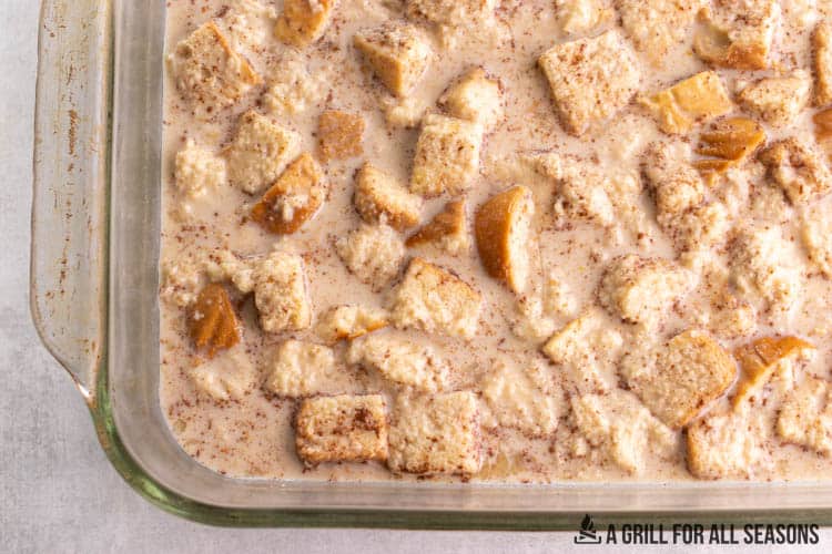 raw cubes of challah in liquid in casserole dish