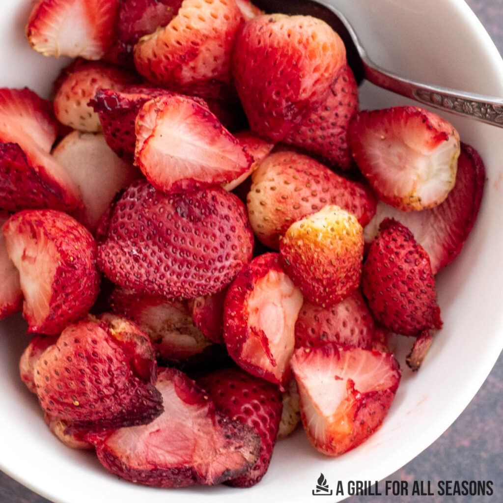 strawberries in bowl with a sppon