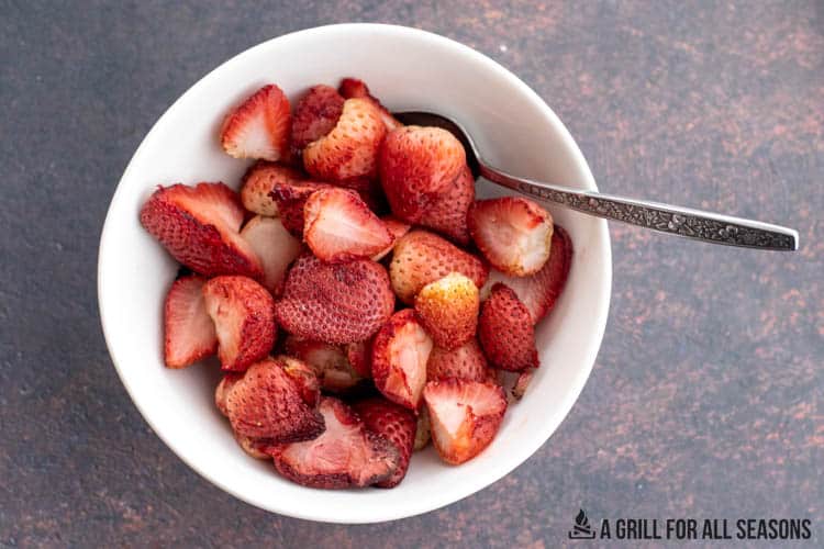 smoked strawberries in bowl with spoon