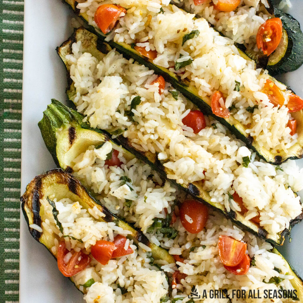 stuffed zucchini with rice on a rectangular serving plate