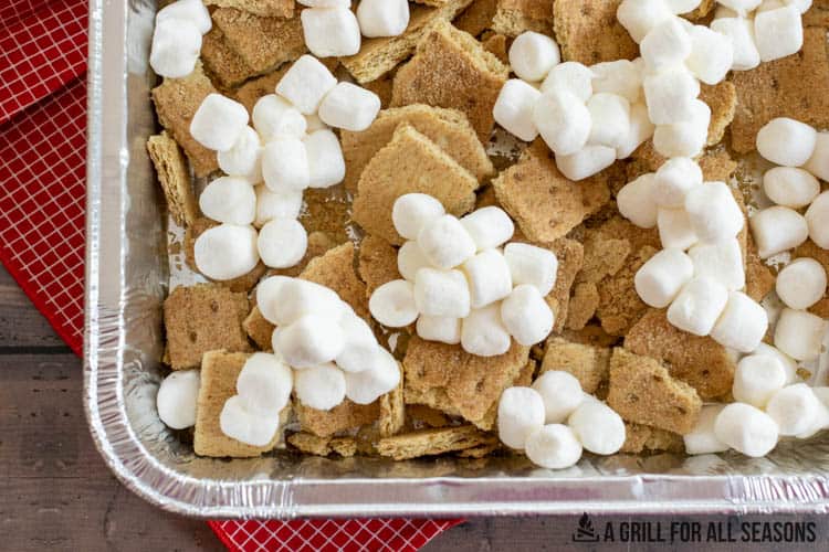 aluminum pan with graham crackers and mini marshmallows