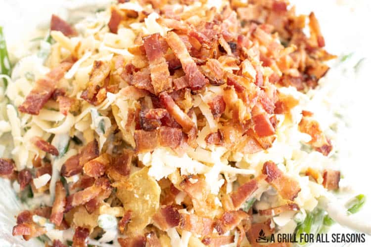 bacon on top of ingredients in dish