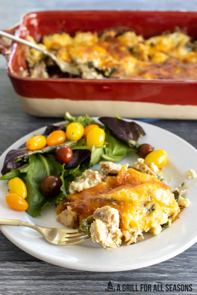 poblano chicken casserole served on a plate with salad