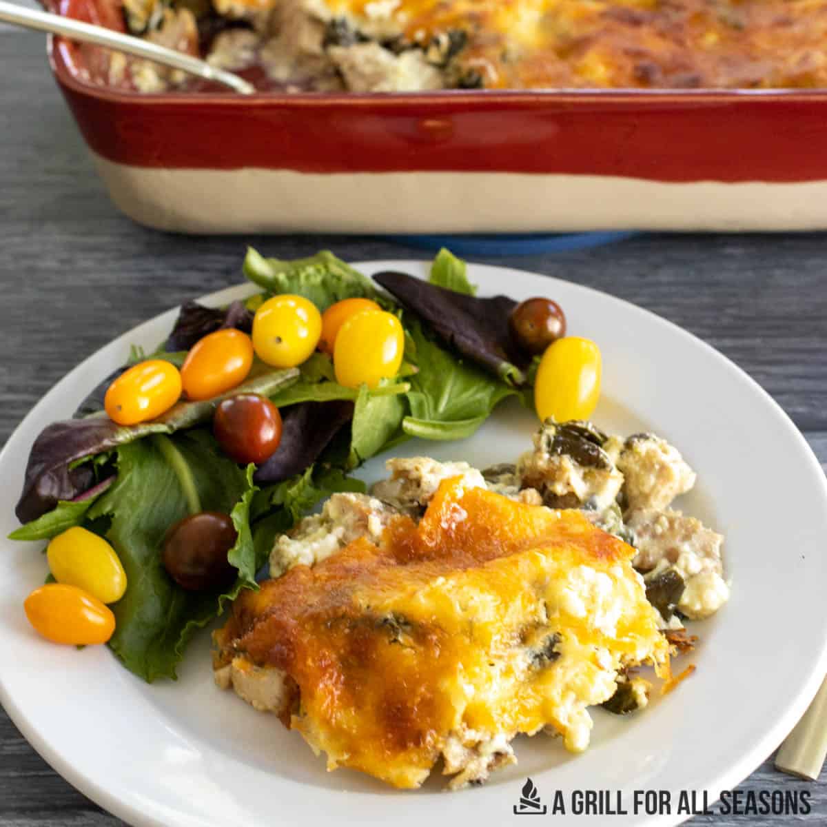 chicken poblano casserole recipe served on a white plate with a side salad