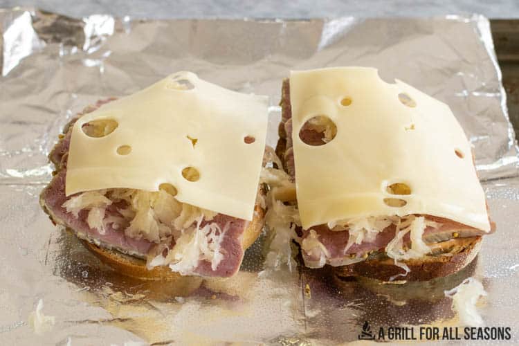 reuben sandiwch assembled with swiss cheese on top