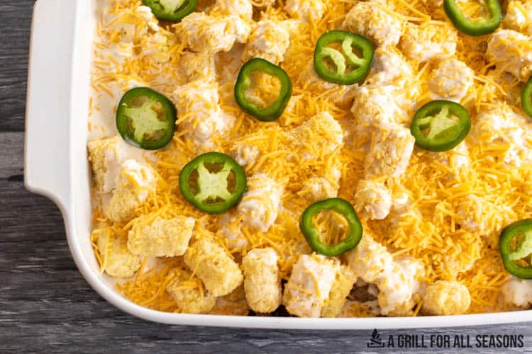tater tot casserole topped with jalapenos