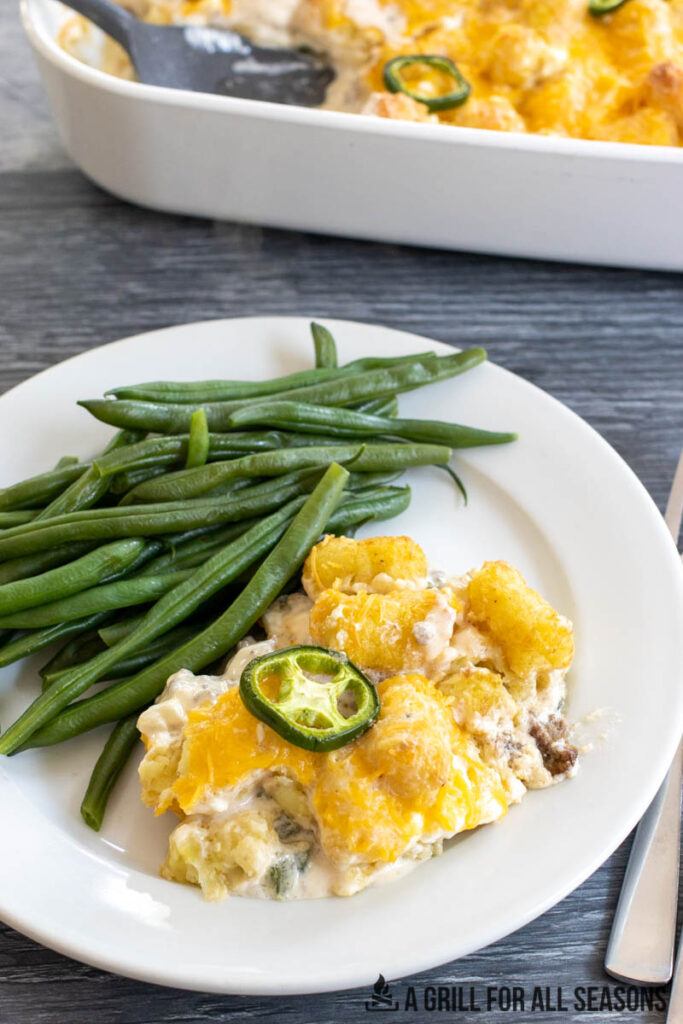 jalapeno tater tot casserole plated with string beans