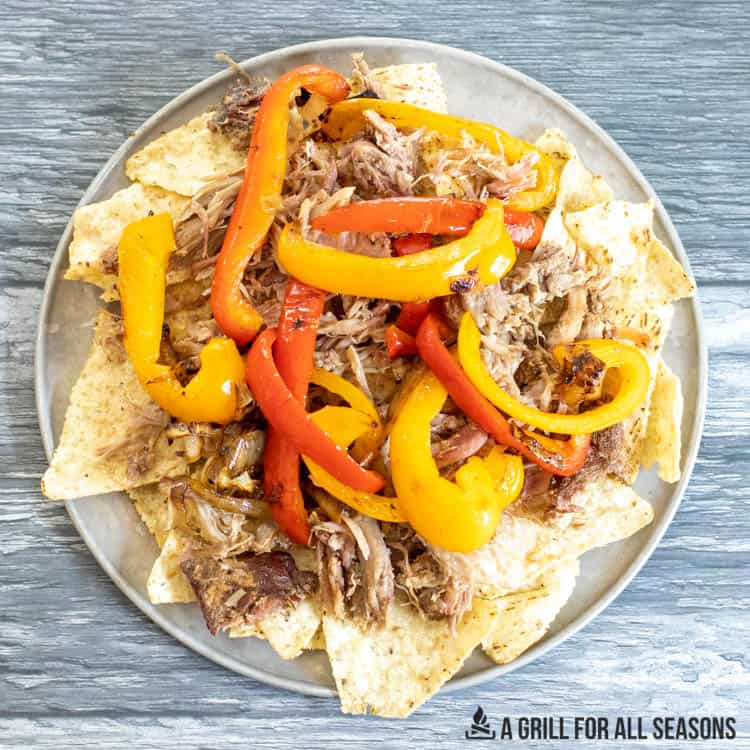 tortillas topped with pork and sauteed onions and peppers