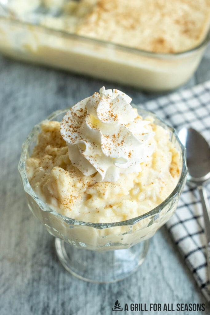 dish of irish rice pudding recipe topped with whipped cream and cinnamon