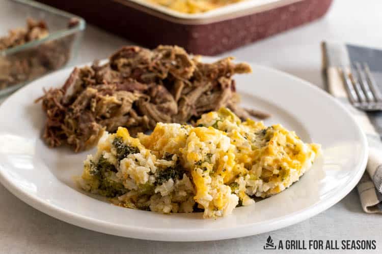 plated southern broccoli rice casserole recipe next to pulled pork
