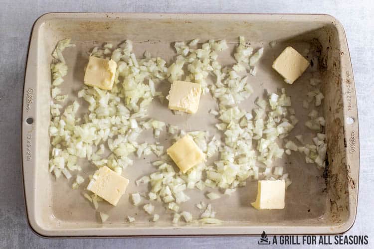 butter and chopped onions in baking dish