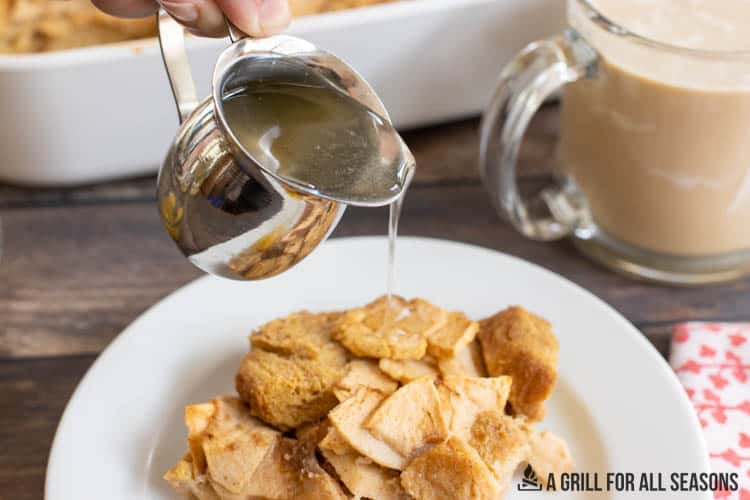 apple syrup being poured over piece of french toast