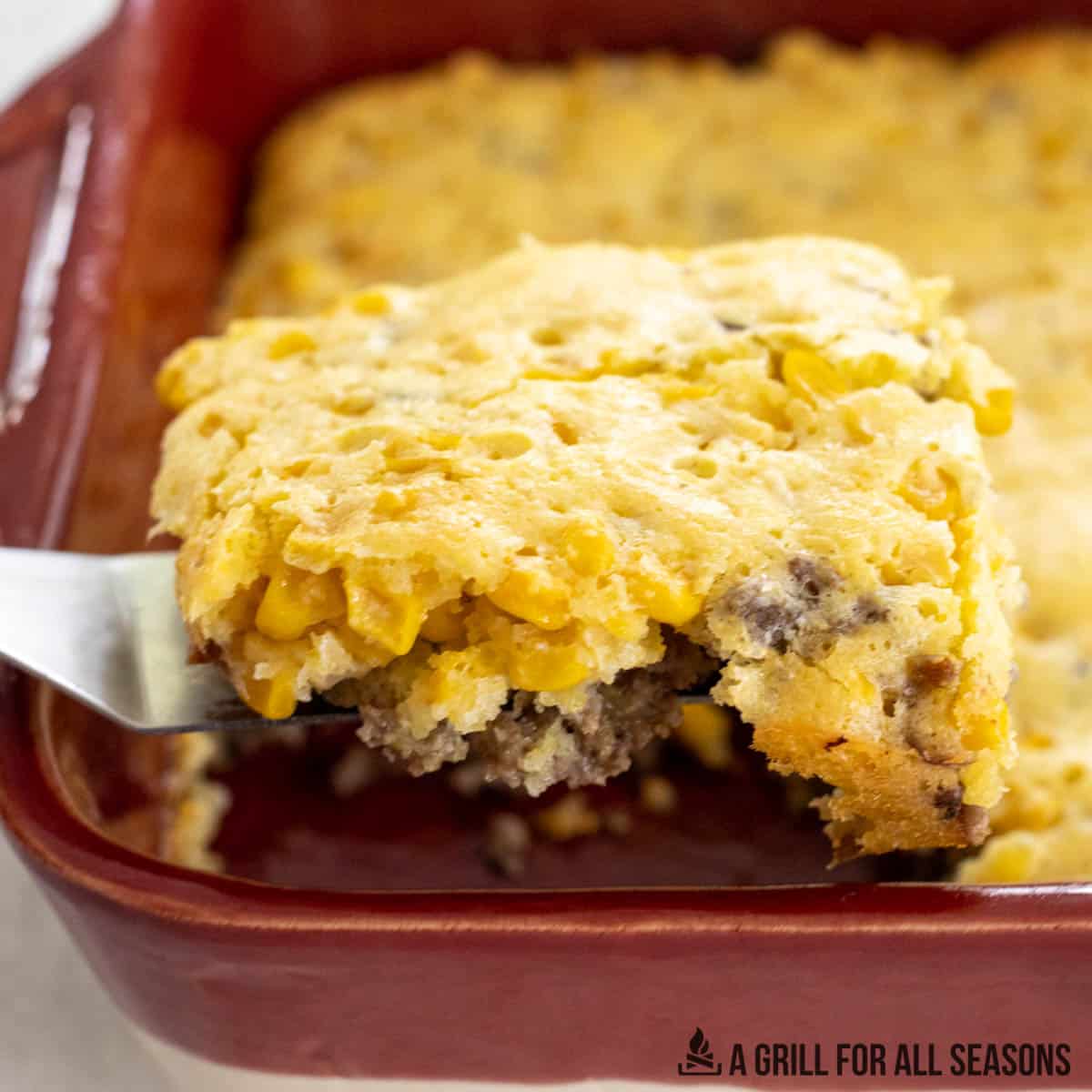hamburger corn casserole recipe being lifted from dish with spatula