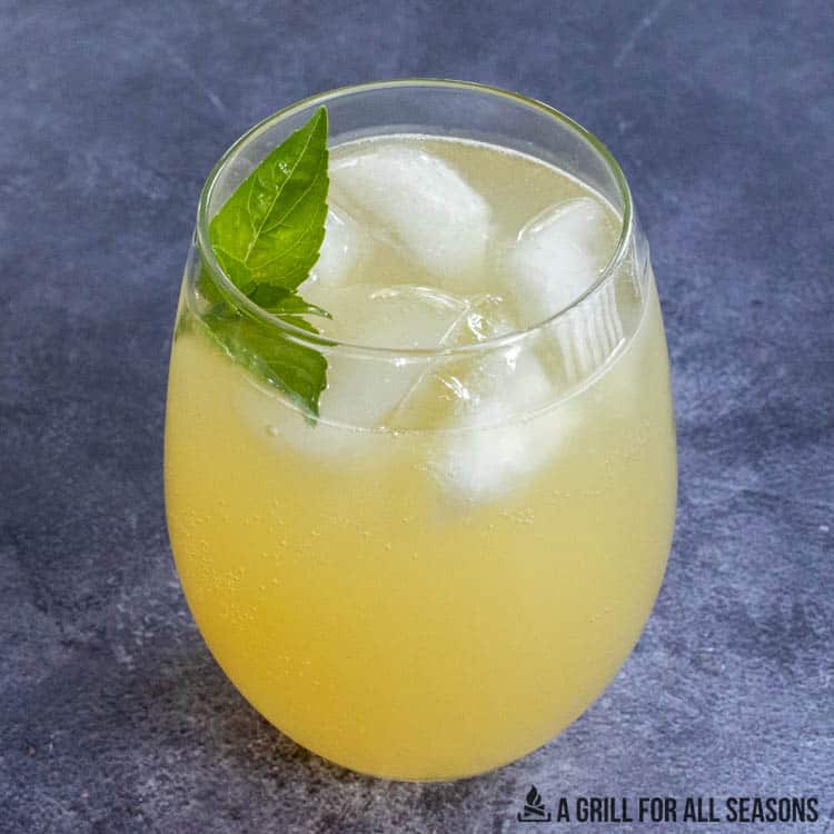 irish lemonade in glass with basil garnish