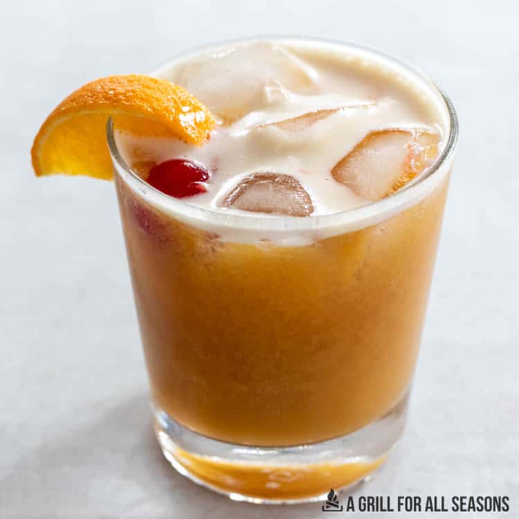 mamajuana cocktail recipe with dominican republic rum in rocks glass garnished wirth orange and cherry