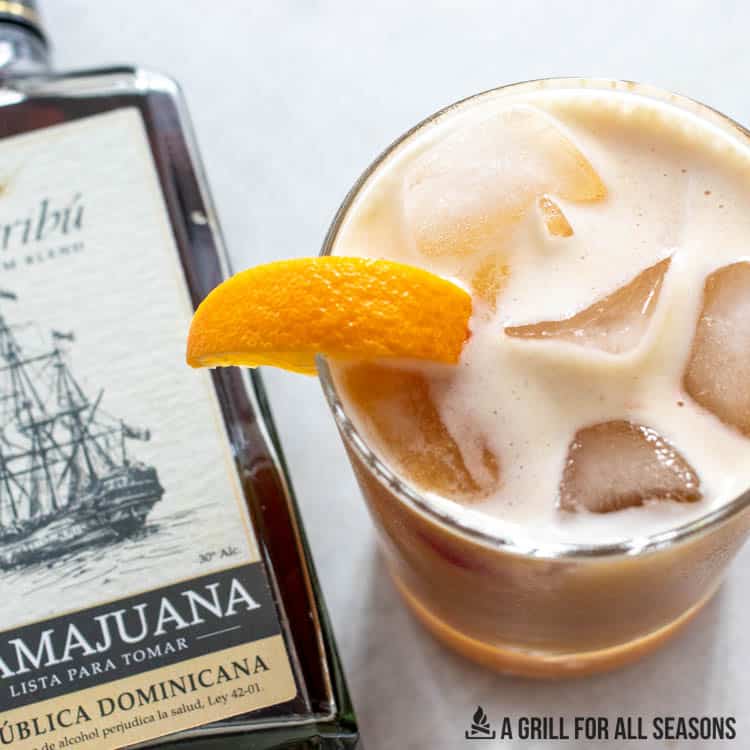 mamajuana cocktail recipe next to bottle of liquor