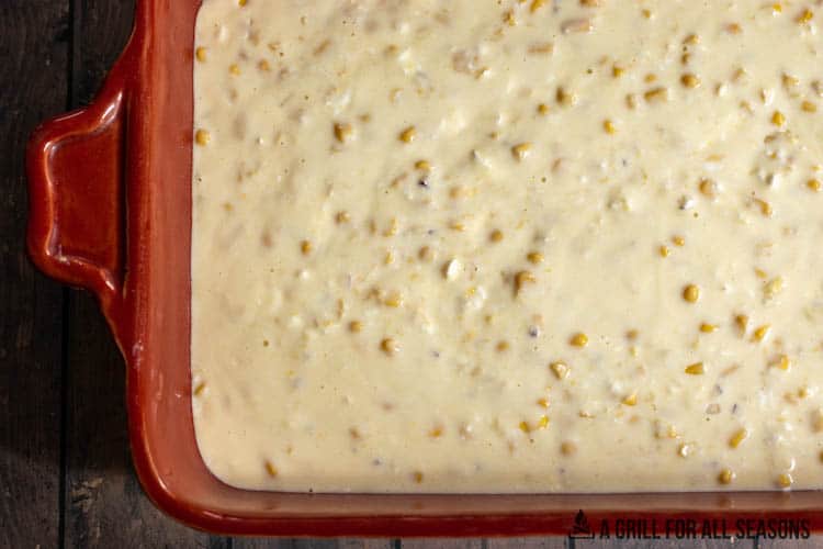 corn casserole recipe with cream cheese and other ingredients in casserole dish