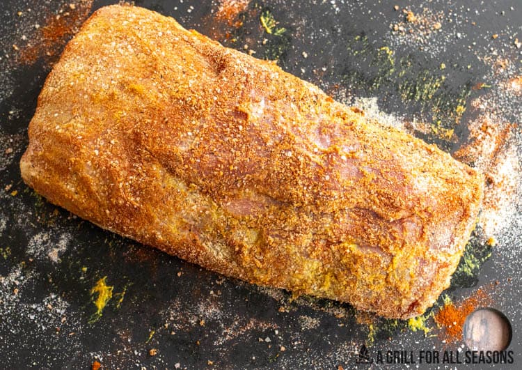 boneless pork roast seasoned on cutting board
