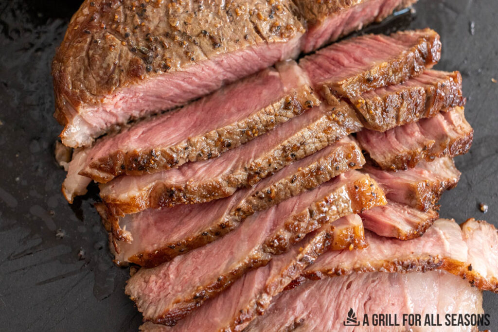 sliced steak on cutting board